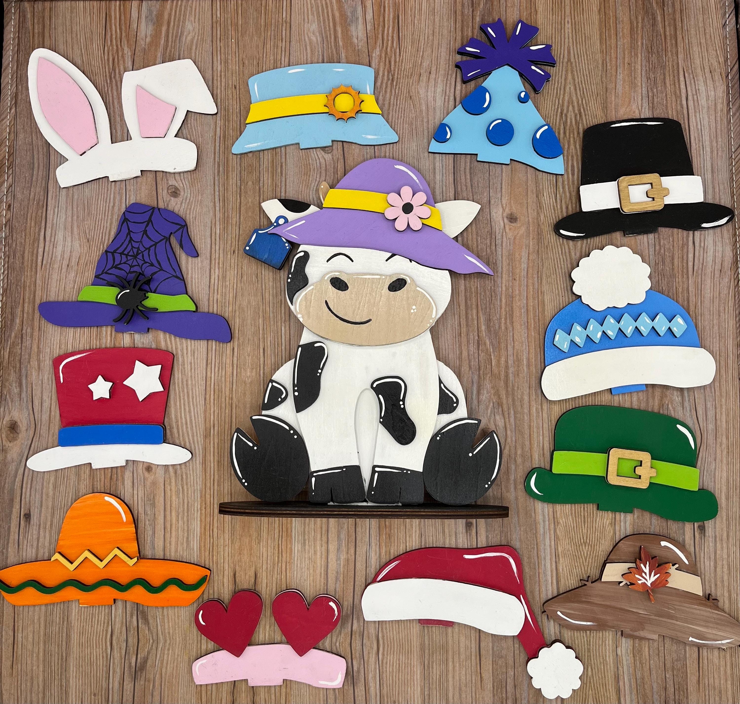 Dairy Cow Interchangeable Desk Buddy with 13 Seasonal and Holiday Hats