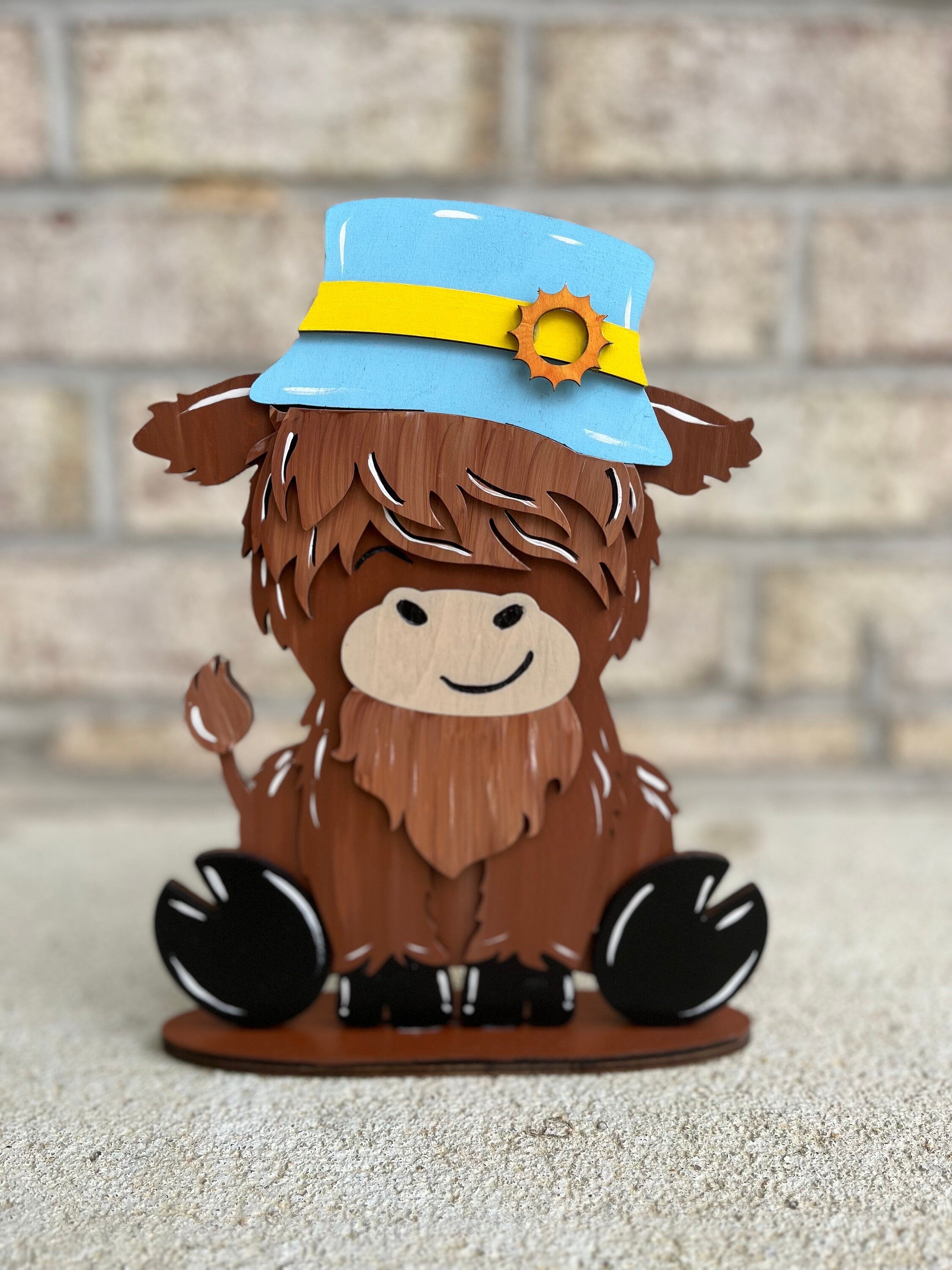 Cute Highland Cow Desk Buddy with Interchangeable Seasonal Hats