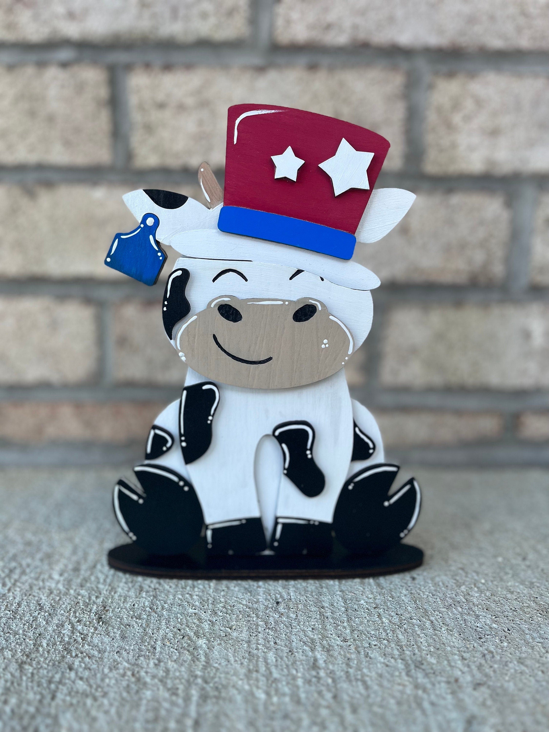 Dairy Cow Interchangeable Desk Buddy with 13 Seasonal and Holiday Hats