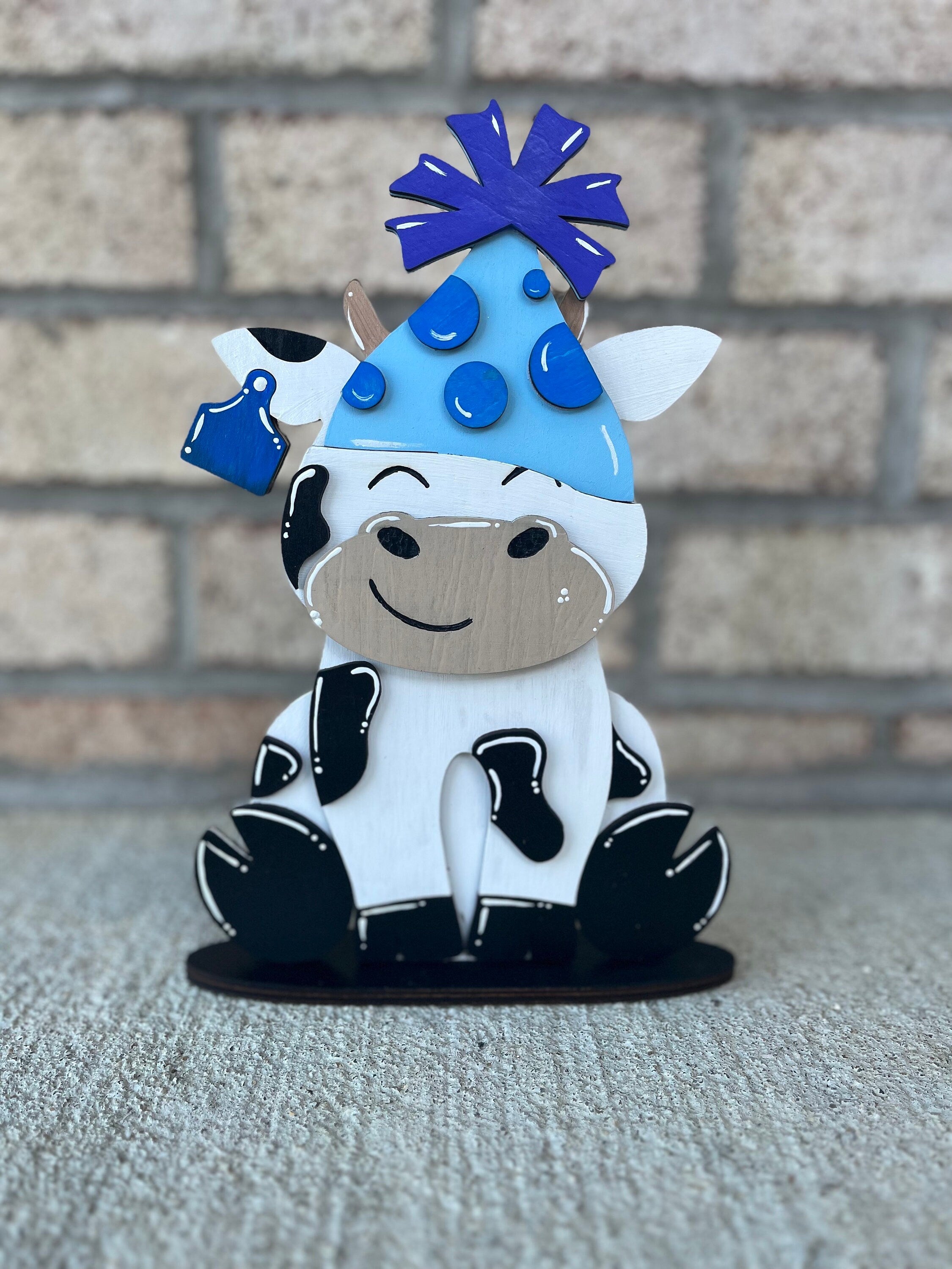 Dairy Cow Interchangeable Desk Buddy with 13 Seasonal and Holiday Hats