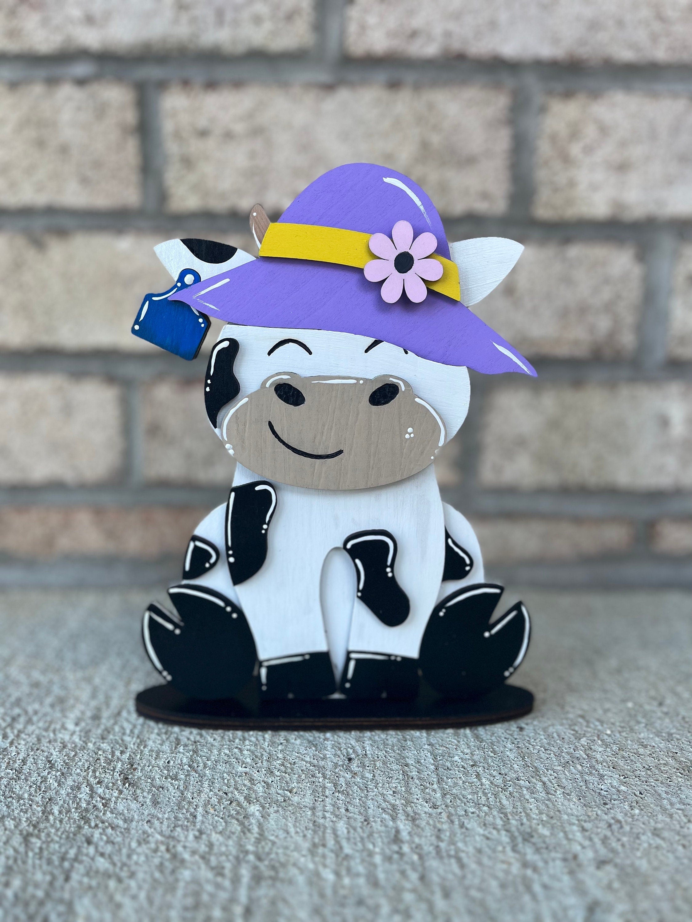 Dairy Cow Interchangeable Desk Buddy with 13 Seasonal and Holiday Hats
